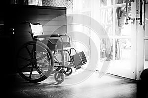 Empty wheelchair in front of the restaurant with antique black and white  film camera effect. Preparing for disable customers