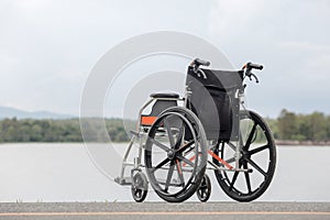 Empty wheelchair on lake