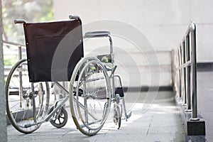 Empty wheelchair parked in hospital