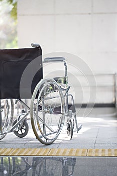 Empty wheelchair parked in hospital