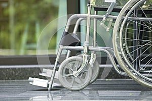 Empty wheelchair parked in hospital