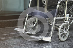 Empty wheelchair parked in hospital