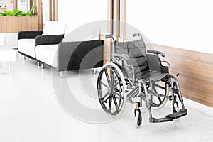 Empty wheelchair parked in hospital hallway