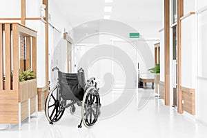 Empty wheelchair parked in hospital hallway