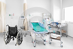 Empty wheelchair parked in hospital room with beds and comfortable medical equipped in a modern hospital