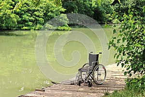 Empty wheelchair on a wooden pier