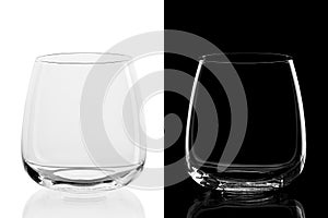 Empty whiskey tumbler glasses on black and white background