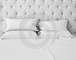 Empty white bed and pillows with luxury headboard