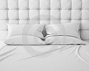 Empty white bed and pillows with luxury headboard