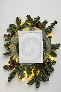 Empty white border with garland of fir branches and lights on a white background