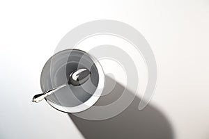 Empty White Bowl with Spoon on a White Background