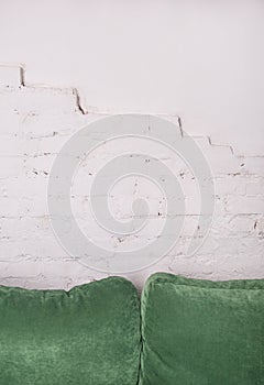 Empty white brick wall with pillows on the sofa. Mock up for design