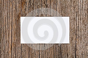 Empty white card over wooden background