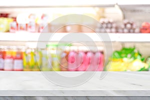 Empty white cement table over blur product shelf at grocery supermarket in shopping mall background, for product display