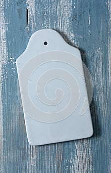 Empty white ceramic chopping board - vertical