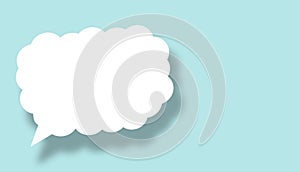 Empty white cloud paper speech bubble shape against light blue background