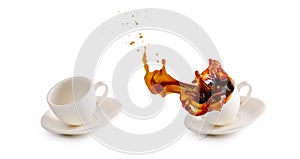 Empty white coffee cup and hot coffee cup spilling on floor with water splash isolated on white background