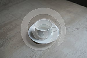 Empty white coffee cup with saucer.