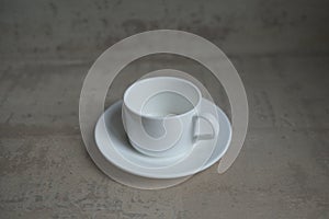 Empty white coffee cup with saucer.