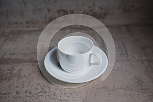 Empty white coffee cup with saucer.