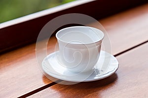 Empty white coffee cup  or tea cup on wood table.