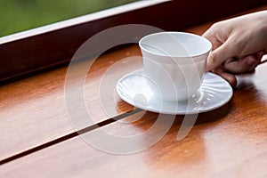 Empty white coffee cup  or tea cup on wood table.