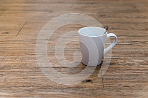 Empty white coffee mug on wooden table