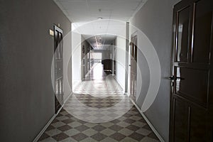 Empty white corridor with closed doors