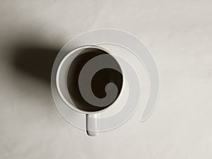 Empty white cup on a light background. Cup with place for text. Copyspace