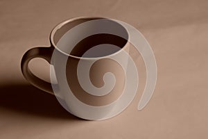 Empty white cup on a light background. Cup with place for text. Copyspace