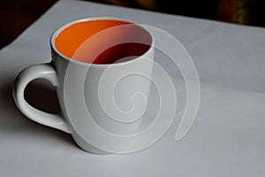 Empty white cup on a light background. Cup with place for text. Copyspace