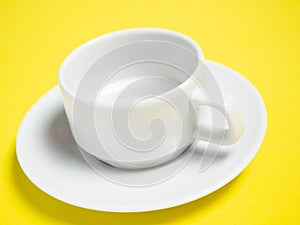 An empty white cup and saucer