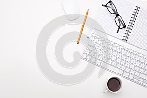 Empty white desk office with glasses pencil coffee and keyboard