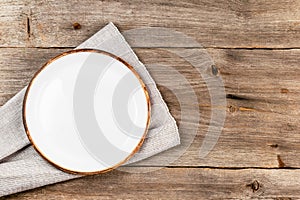 Empty white dish on rustic wooden table