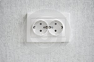 Empty white electrical outlet on the wall. Double power European electric plug . electricity socket on white background