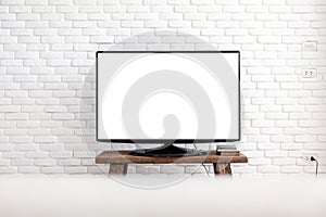 Empty white flat TV screen hanging on a white wall