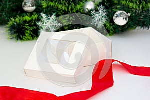 Empty White gift box with red ribbon on white background. Christmas tree garland. Holiday Horizontal template