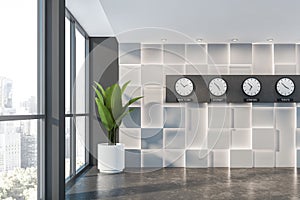 Empty white and gray office lobby with clocks