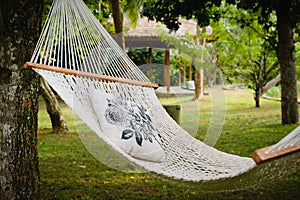 Empty white hammock with pillow