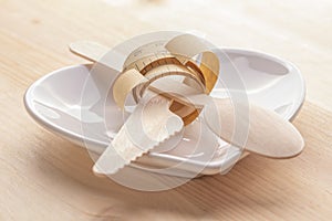 Empty plate with measure tape, knife and fork. Diet food on wooden table