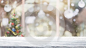 Empty white mable stone table top on blur with bokeh Christmas tree and new`s year decoration on window background with snowfall