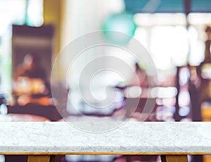 Empty white marble table and blurred cafe bokeh light background