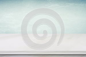 Empty white marble table over green cement wall background