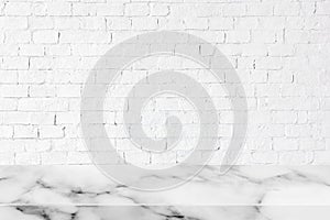 Empty white marble table on white brick wall background.