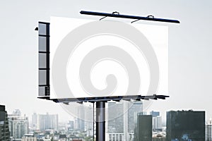 Empty white mock up bill board in dull city sky. Commercial concept.