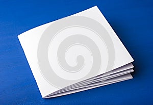 Empty white paper for notes, notebook, diary, booklet, organizer on a blue background.