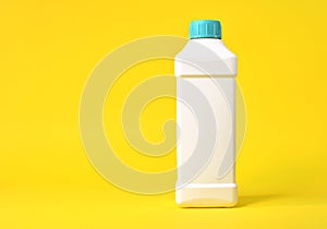 Empty white plastic bottle on a yellow background