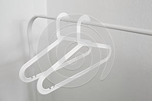 Empty white plastic clothes hangers