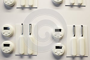 Empty white plastic plate, cup, fork and spoon over white background with copy space. Dining set of plastic cutlery on