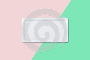 Empty white plate on bicolored background